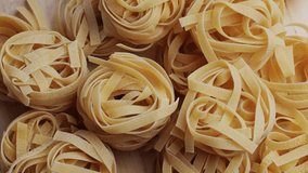 Italian tagliatelle pasta packaging window, Fettuccine pasta, close up, not cooked - Powered by Shutterstock - Get 15% off with code: PIKWIZARD15