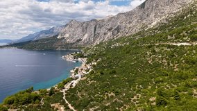 Makarska Riviera Dalmatia Croatia drone panorama of coastal village turquoise bay and dramatic Biokovo mountains - Powered by Shutterstock - Get 15% off with code: PIKWIZARD15