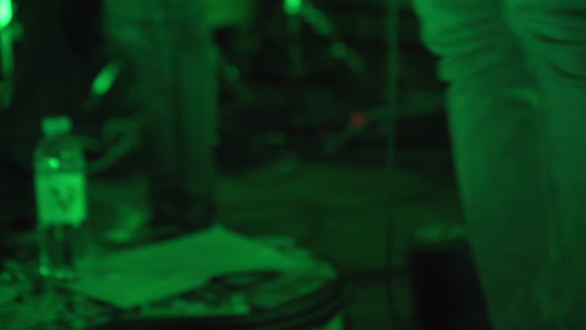Indie rock guitarist stomps effects pedals on stage — handheld, flashing lights, real time