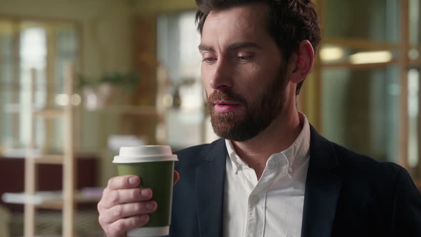 Caucasian business man guy drink coffee in office morning delicious beverage foretaste businessman enjoying aroma smell drinking hot cup tea male happy employer enjoy anticipation taste caffeine tasty