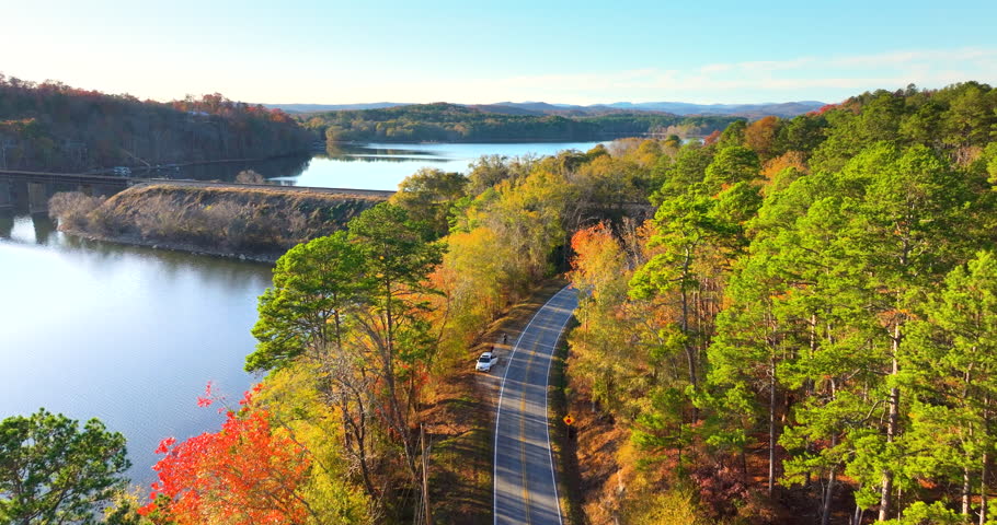 Golden autumn landscape in Appalachian mountains of South Carolina. Forest road winds through hills with vibrant fall foliage