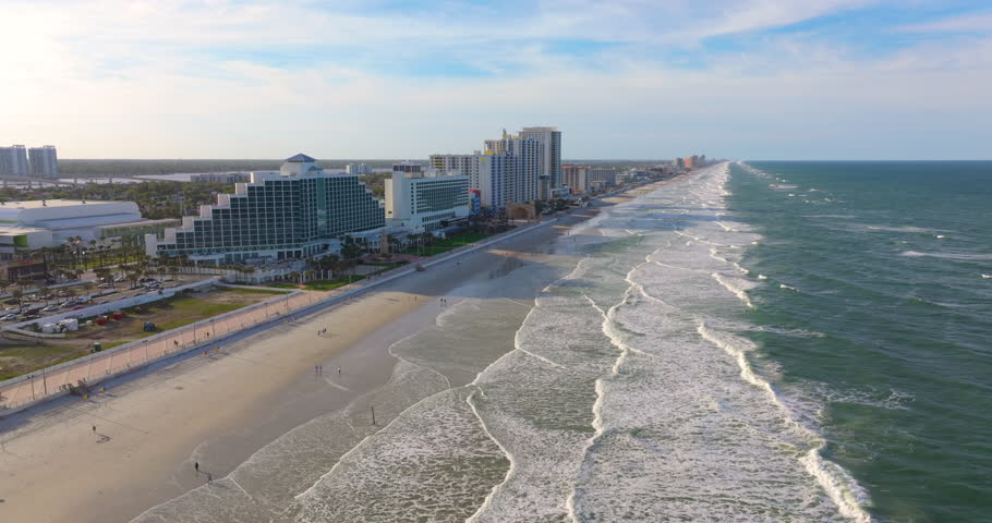 View from above of Daytona Beach city, Florida. High-rise luxury hotels and apartment buildings near sandy beach and Atlantic Ocean.