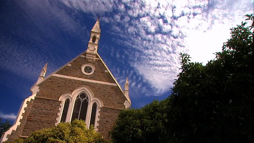 Old church steeple with clouds