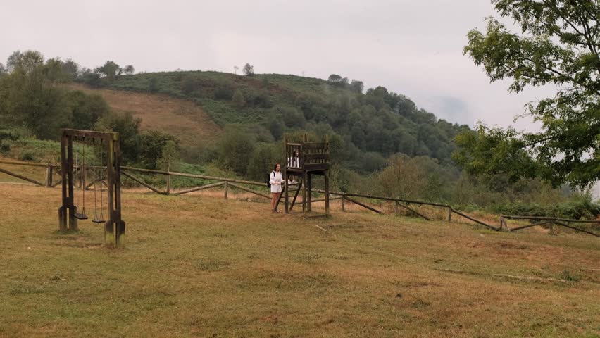 Mother and Daughter on Wooden Lookout Tower, Rear View