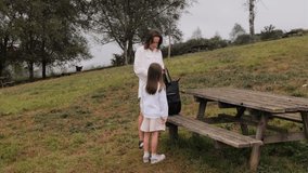 Mother and Daughter Unpacking Picnic at Park Table, Side View - Powered by Shutterstock - Get 15% off with code: PIKWIZARD15
