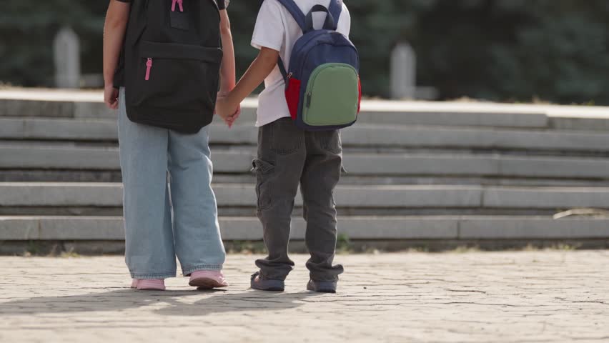 Two children walking upstairs hand in hand on a school morning. A slow-motion moment symbolizing growth, learning, and shared journey into the future.