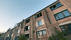 Abandoned Industrial Brick Building with Broken Windows at Sunset | Old Factory Architecture Shot from Below | Wide-Angle Urban Decay Structure - Powered by Shutterstock - Get 15% off with code: PIKWIZARD15