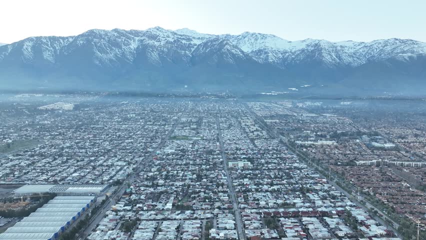 Santiago city in Chile. Aerial view of the skyline of buildings and snowy mountain.