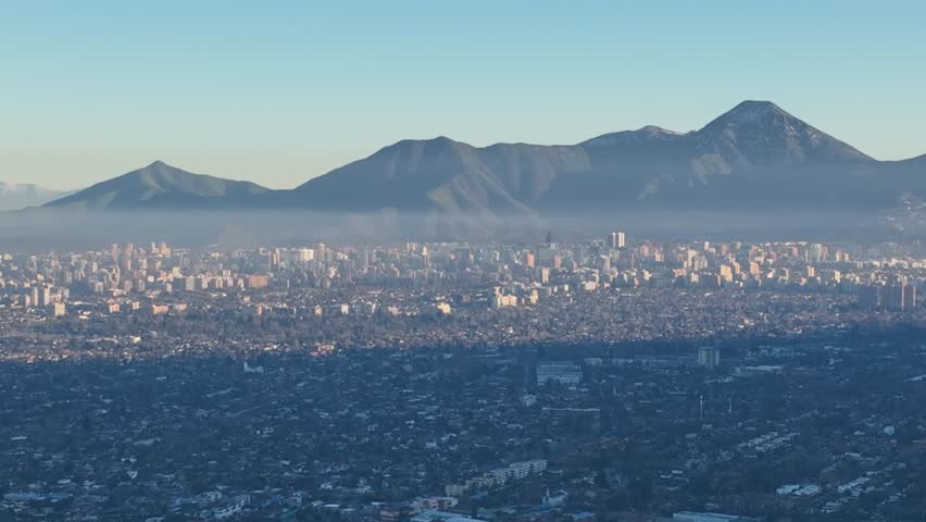 Santiago city in Chile. Aerial view of the skyline of buildings and snowy mountain.