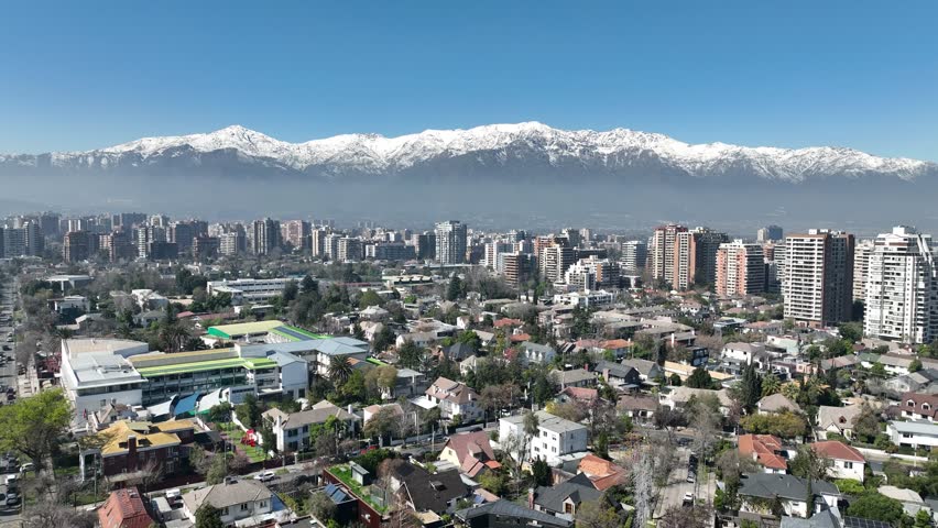 Santiago city in Chile. Aerial view of the skyline of buildings and snowy mountain.