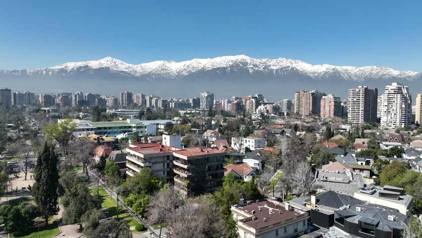 Santiago city in Chile. Aerial view of the skyline of buildings and snowy mountain.