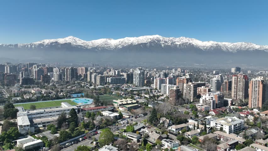 Santiago city in Chile. Aerial view of the skyline of buildings and snowy mountain.