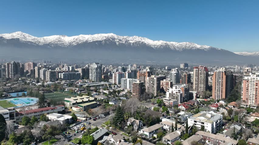 Santiago city in Chile. Aerial view of the skyline of buildings and snowy mountain.
