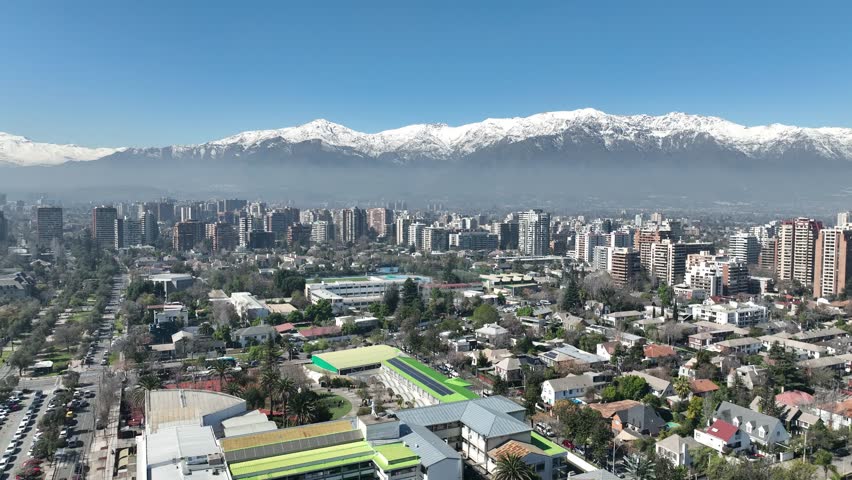 Santiago city in Chile. Aerial view of the skyline of buildings and snowy mountain.