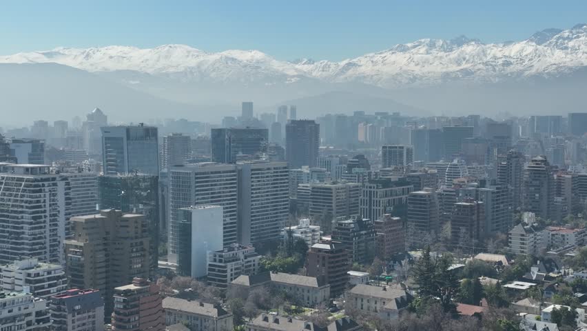 Santiago city in Chile. Aerial view of the skyline of buildings and snowy mountain.