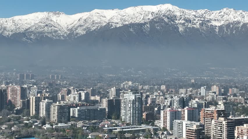 Santiago city in Chile. Aerial view of the skyline of buildings and snowy mountain.