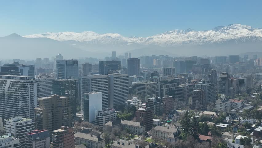 Santiago city in Chile. Aerial view of the skyline of buildings and snowy mountain.