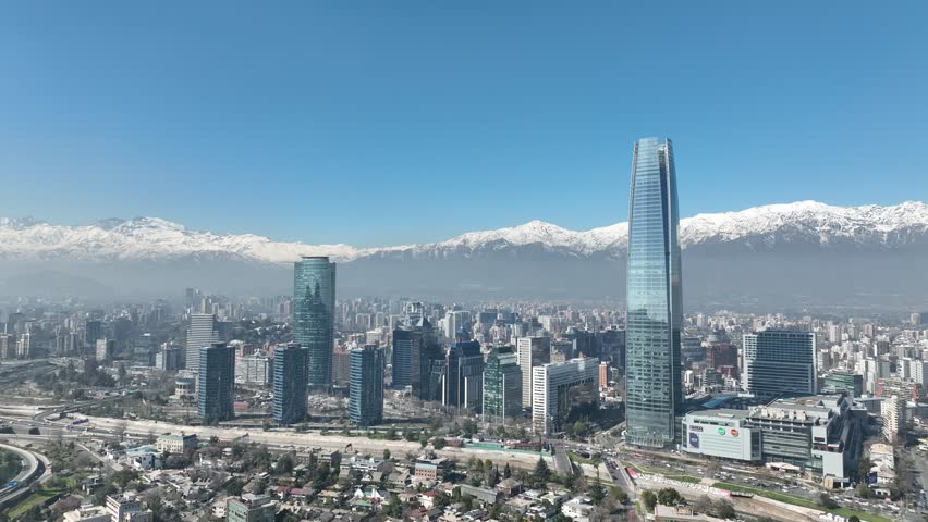 Santiago city in Chile. Aerial view of the skyline of buildings and snowy mountain.