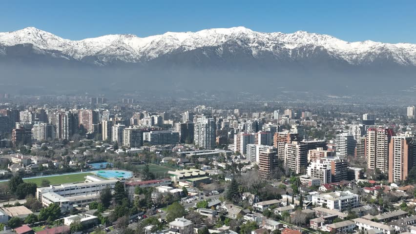Santiago city in Chile. Aerial view of the skyline of buildings and snowy mountain.
