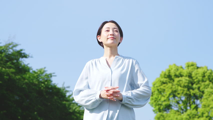 Japanese Woman Stretching Outdoors for Relaxation and Wellness
