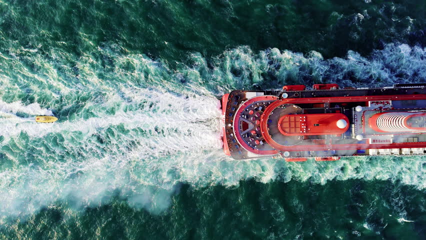 Luxury Cruise Liner left Miami harbor and goes to the horizon, above aerial view of luxury cruise in the ocean. 