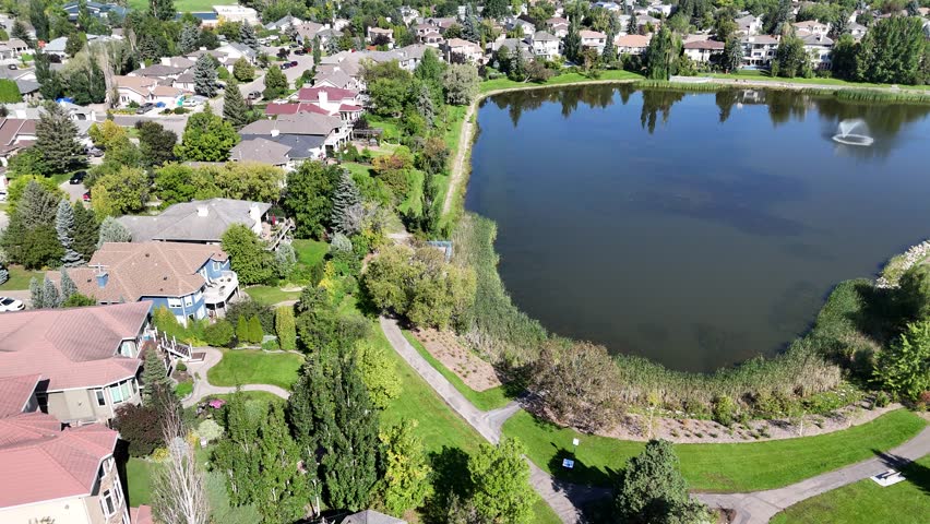4K aerial footage showing the homes, streets, and green spaces of Arbor Creek in Saskatoon.