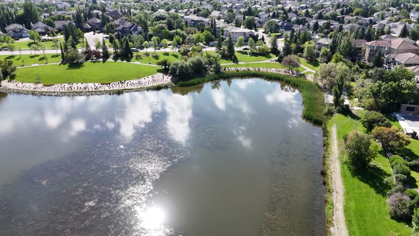 4K aerial footage showing the homes, streets, and green spaces of Arbor Creek in Saskatoon.