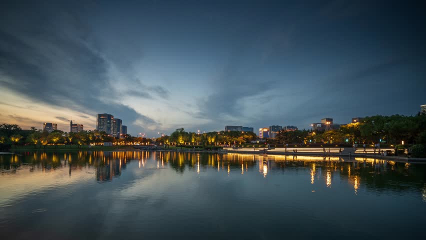 Tranquil Urban Reflections: A Serene Dusk Over the City Lake