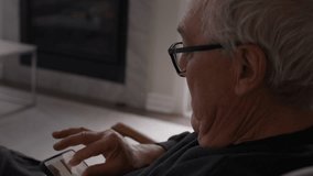 Senior man looking at details of zoomed in photo on smart phone - side profile - Powered by Shutterstock - Get 15% off with code: PIKWIZARD15