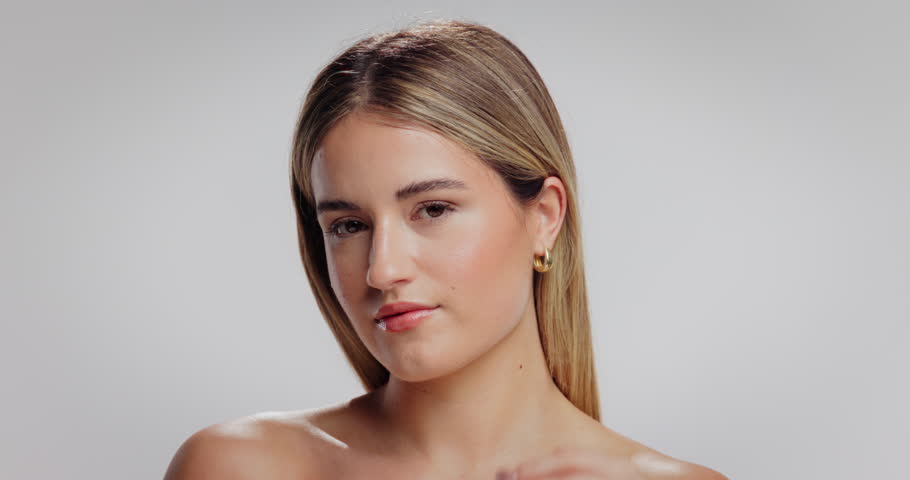 Face, serum and woman in studio, cosmetics and skincare oil routine on white background. Space, dropper and person with wellness, shine and glow with hydration, retinol dermatology or hyaluronic acid