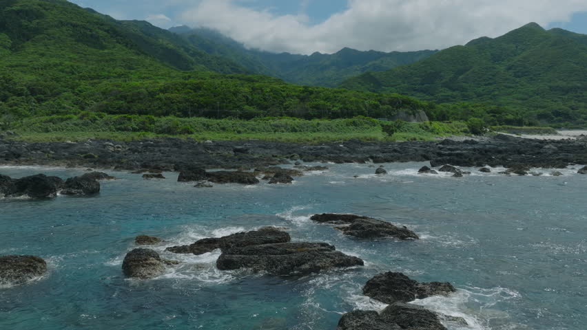  Aerial drone footage of Yakushima island coastline in southern Japan, showing turquoise sea, lush subtropical forest, and UNESCO World Heritage nature landscape.