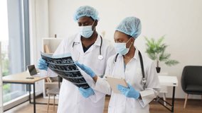 Confident male and female doctors collaborate using patient scans and digital tablets. Health professionals showcase teamwork, expertise promoting medicine, diagnostics, progress. - Powered by Shutterstock - Get 15% off with code: PIKWIZARD15