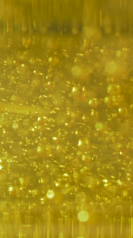 Air bubbles in various sizes are floating in a yellow liquid, creating a sparkling effect. This scene could depict the bubbling process during fermentation