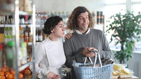 Married couple is looking for fresh produce together in a grocery supermarket. High quality 4k footage - Powered by Shutterstock - Get 15% off with code: PIKWIZARD15