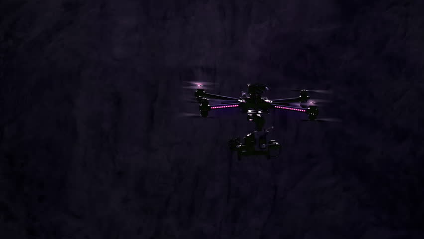 Night Exploration. Quadrocopter powerful moves in the night canyon walls in the moonlight. Slow Motion