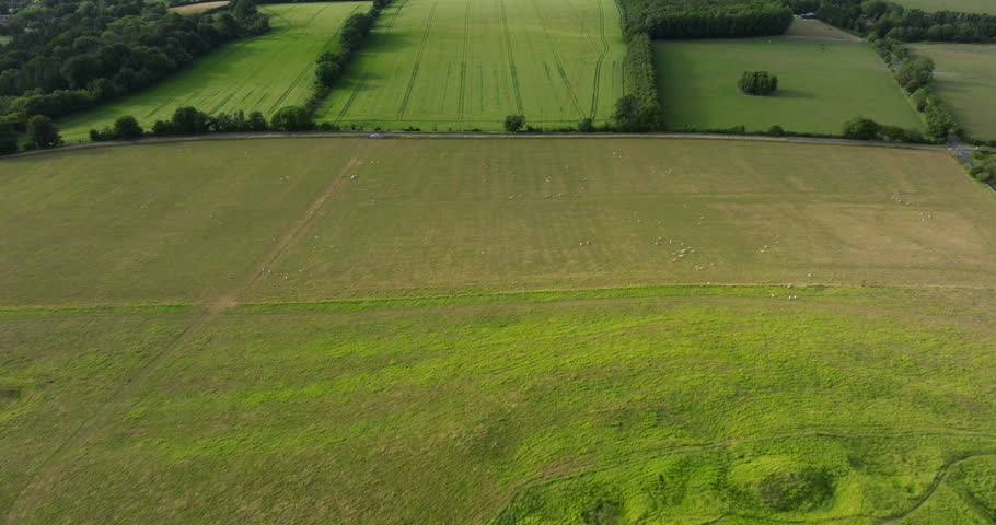 Green Agricultural Fields In Cotswold District, Gloucestershire, England - Drone Shot