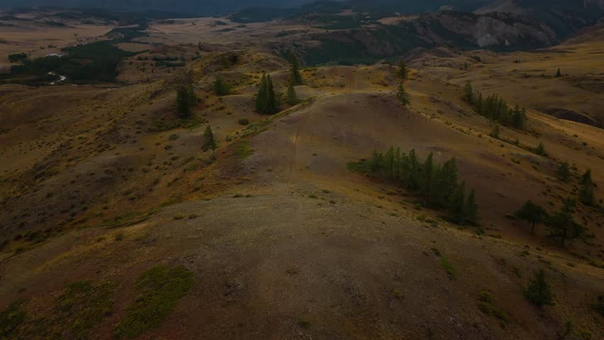 Aerial panorama of Belukha Mountain, the highest peak of Altai. Stunning snowy ridge with dramatic clouds above wide valleys. Perfect for adventure, tourism, and nature themes.