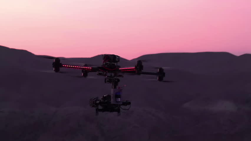 Quadrocopter in the Exploration Area. Powerful quadrocopter curled over the canyon at sunset. Slow Motion