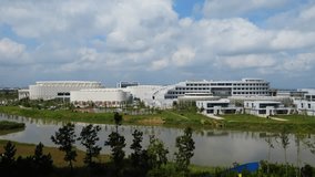Aerial ascending establishing shot of Weihai Olympic Center modern futuristic architecture sports complex in China - Powered by Shutterstock - Get 15% off with code: PIKWIZARD15