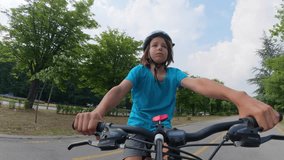 Child riding bicycle with helmet on summer day, close up front view, active lifestyle and outdoor recreation - Powered by Shutterstock - Get 15% off with code: PIKWIZARD15