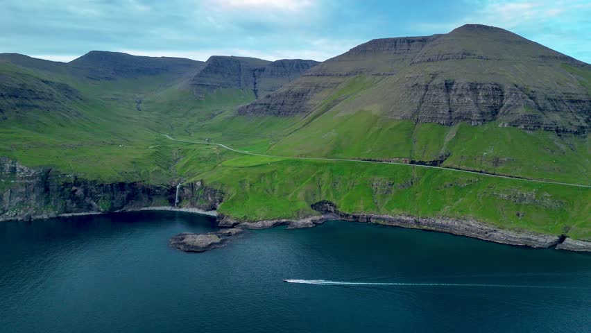 Experience the breathtaking beauty of the Faroe Islands with spectacular cliffs, vibrant green landscapes, and tranquil waters creating a serene atmosphere. Ideal for nature lovers and adventurers.
