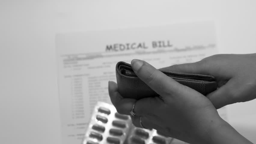 A person shows an empty wallet beside a medical bill and pills, symbolizing the rising healthcare costs and financial burden faced by middle-class people. Black and white video,