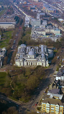 4K drone video of Cardiff’s Cathays Park civic centre, ft. the domed National Museum, tree - lined avenues and cityscape. Vertical for mobile. Ideal for social media reels showcasing Welsh landmarks.