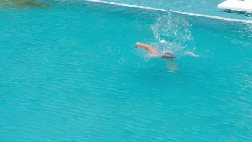 boy swimming in pool, training on vacation