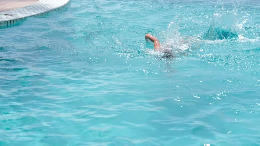 boy swimming in pool, training on vacation