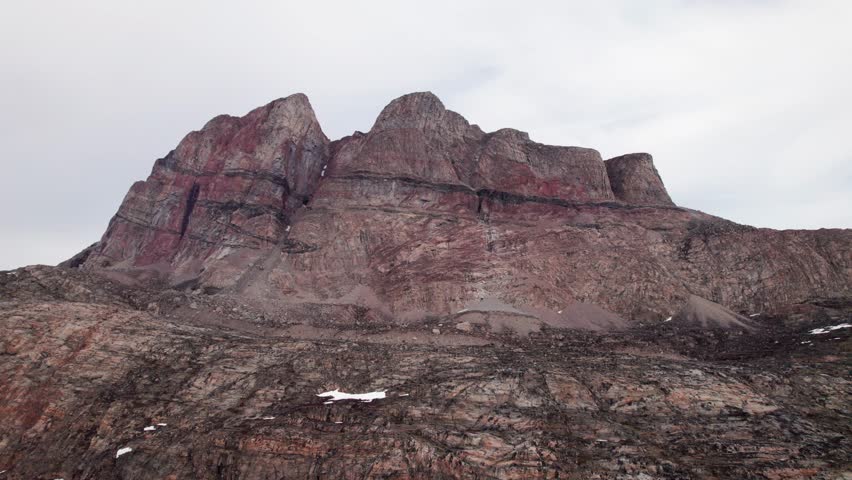 A flight over a landscape carved by ancient glaciers. Witness the raw geology of Greenland