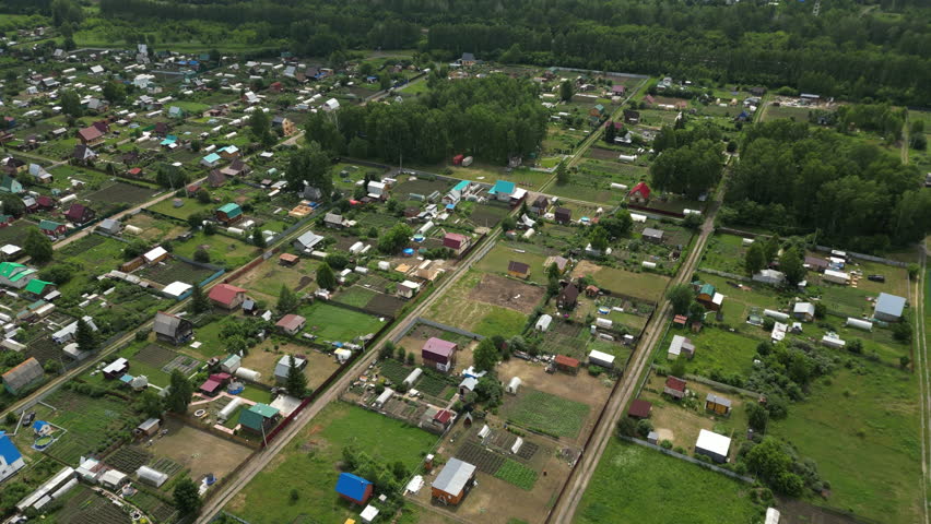 Aerial view of allotment gardens expanding in a rural community, showcasing the growth of small-scale agriculture and sustainable living