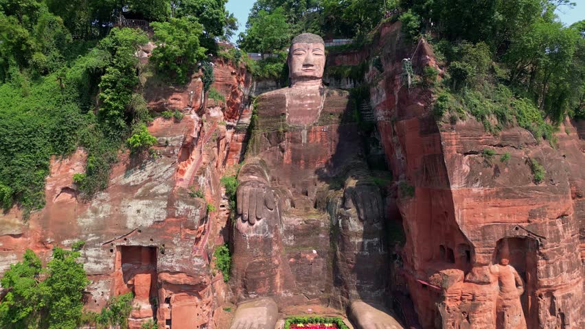 Leshan, China: Aerial drone footage of the famous Leshan giant Buddha stone statue  at the confluence of the Min River and Dadu River in Sichuan in China. Shot with a backward motion