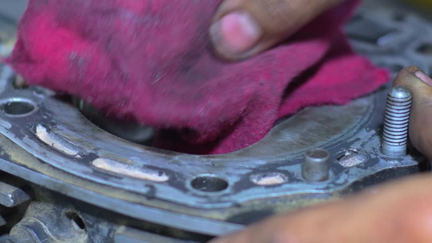Mechanic Cleaning Engine Valves with a Cloth