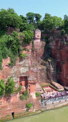 Leshan, China: Aerial drone footage of the famous Leshan giant Buddha stone statue near Chengdu in Sichuan in China. Shot with as a vertical with an orbit motion